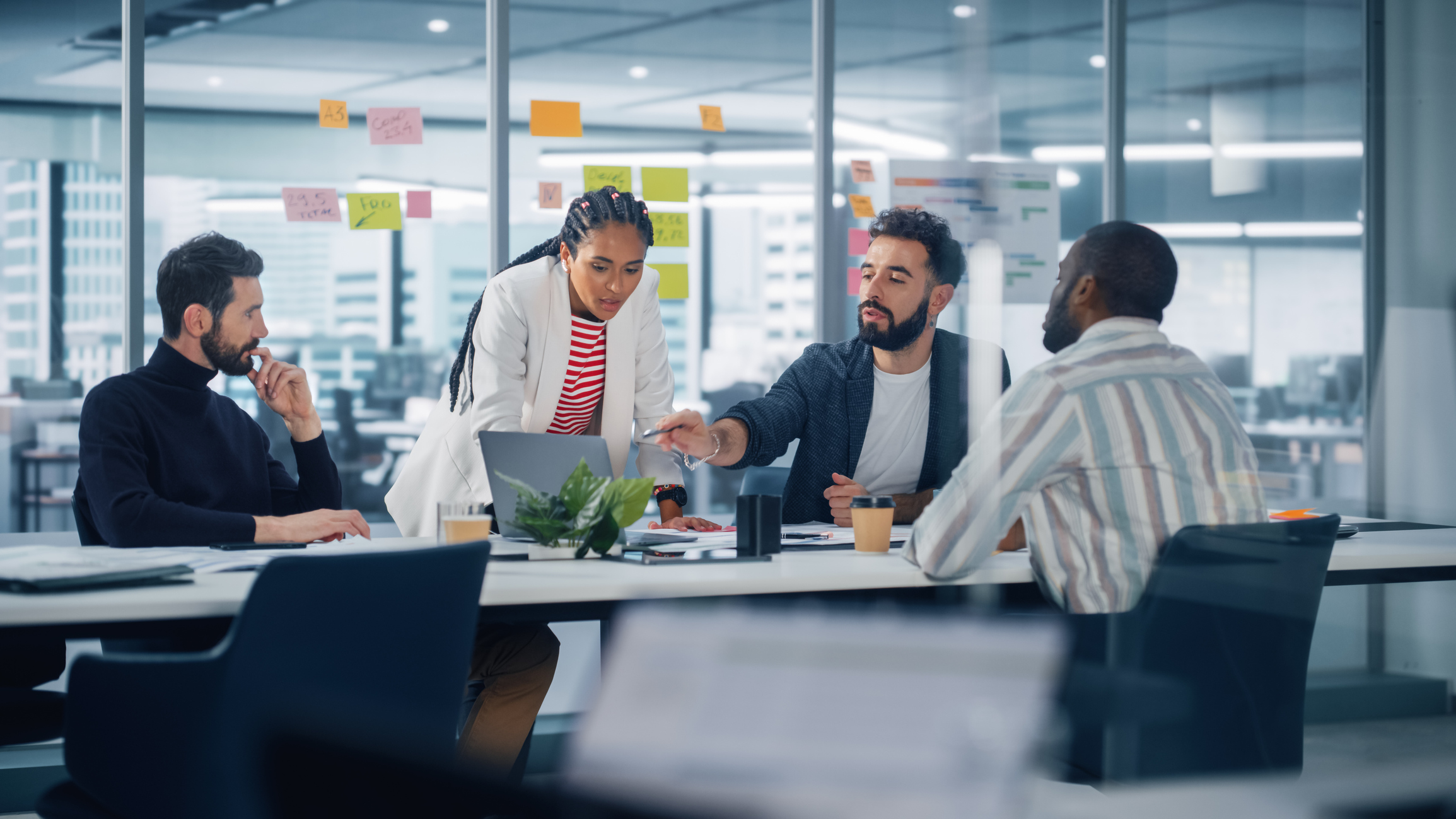 diverse modern office: successful motivated black businesswoman leads meeting, talks of company growth. digital entrepreneurs work on e commerce project. multi ethnic creatives brainstorm strategy