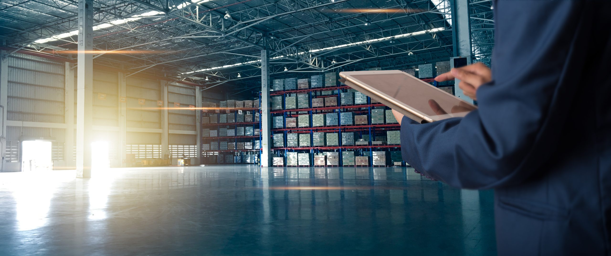 businessman manager using tablet check and control for workers with modern trade warehouse logistics. industry 5.0 concept